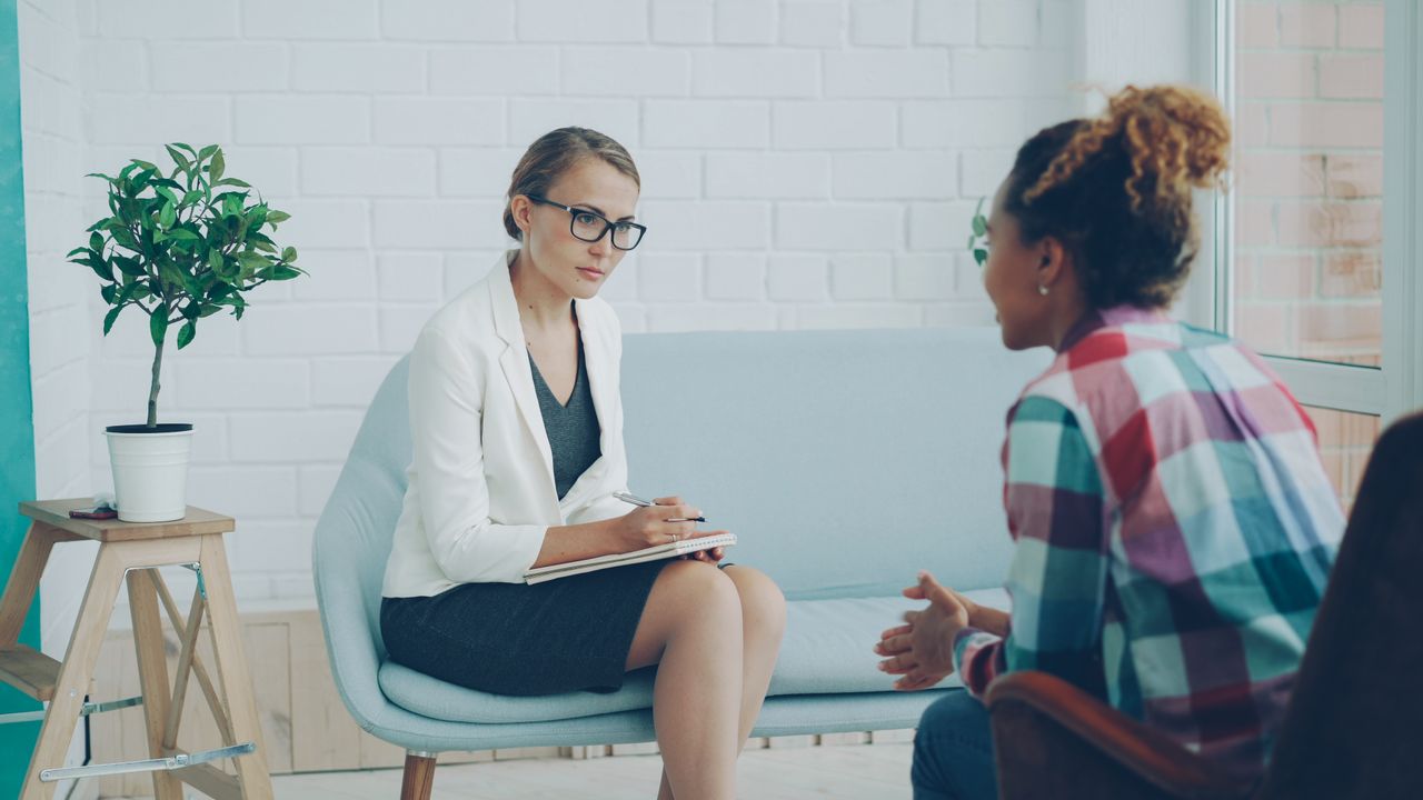 The Art of Drawing Readers In: Your attractive post title goes here Therapist and client in a counseling session within a stylish modern office setting.