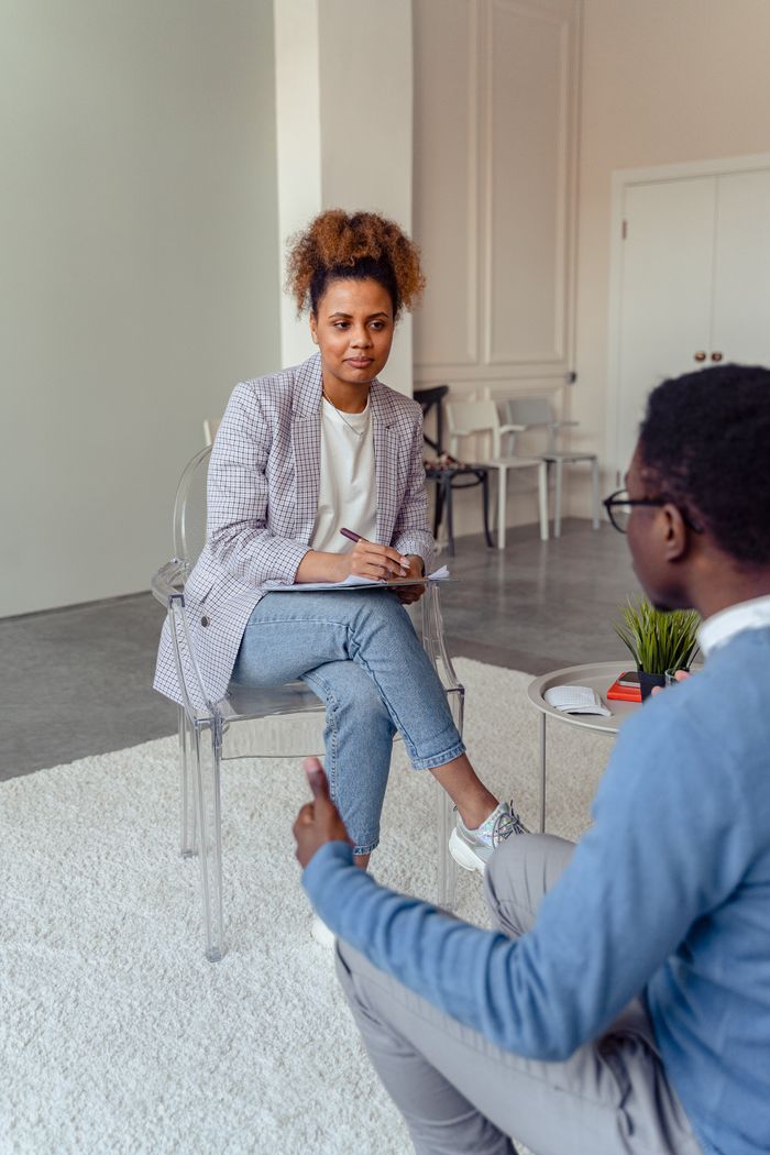 Crafting Captivating Headlines: Your awesome post title goes here Professional therapist discussing with a client in a modern office setting.